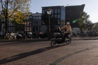 Mann fährt mit dem Ca Go CS durch Amsterdam