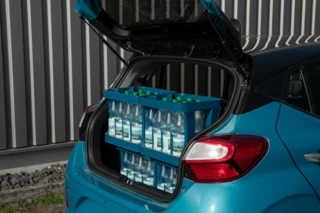 Offener Kofferraum eines Autos mit einigen Wasserkisten darin.